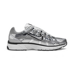 Highlights the inner profile showing the matching chrome overlay cage pattern, black Swoosh, white foam midsole wall, and structured grey mesh heel collar.