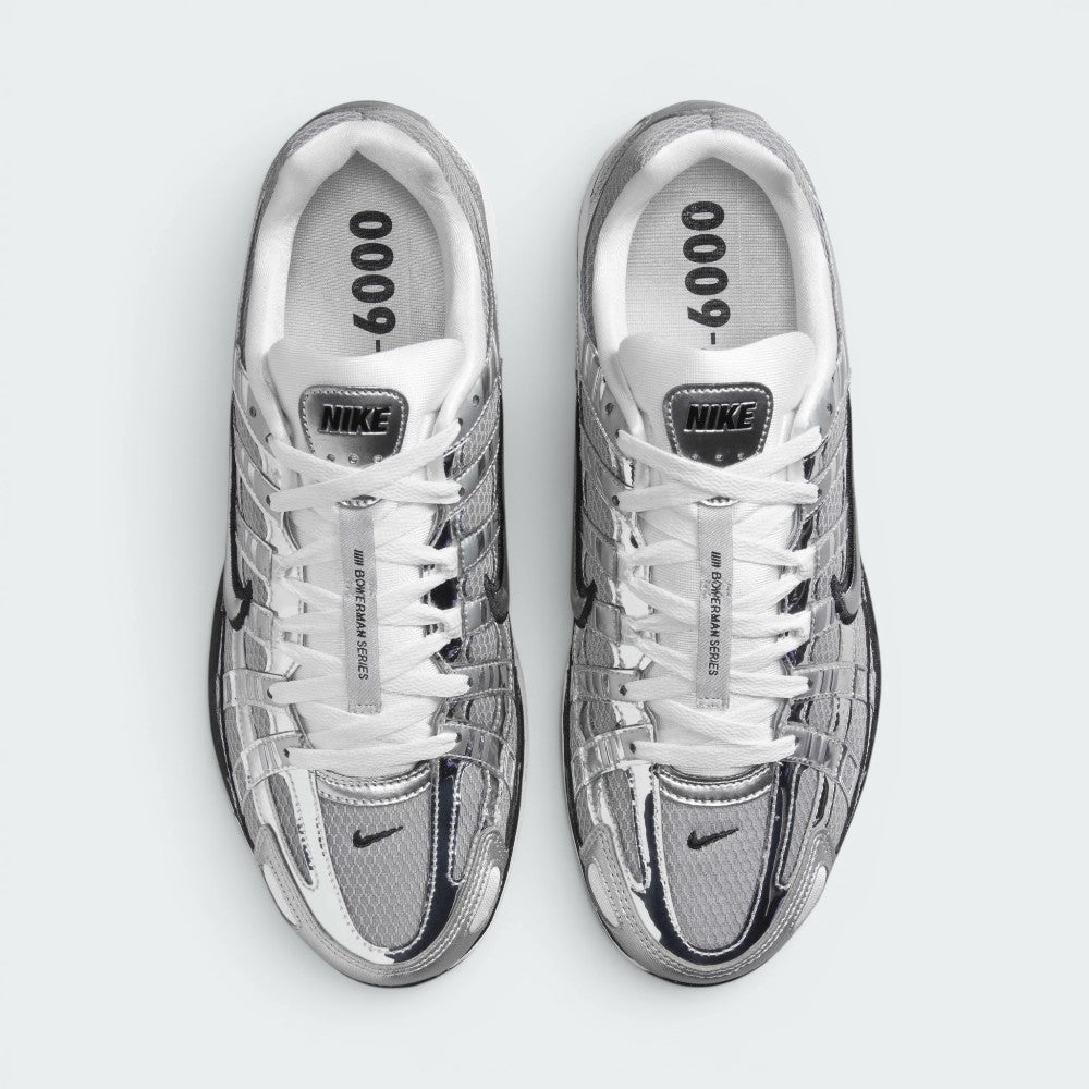 Focuses on the locked-in central lacing layout, displaying the white laces tracking through silver eyestays, central tongue ribbon printed with "BOWERMAN SERIES", metallic tongue tab badge, and insoles printed with bold "P-6000" graphics.