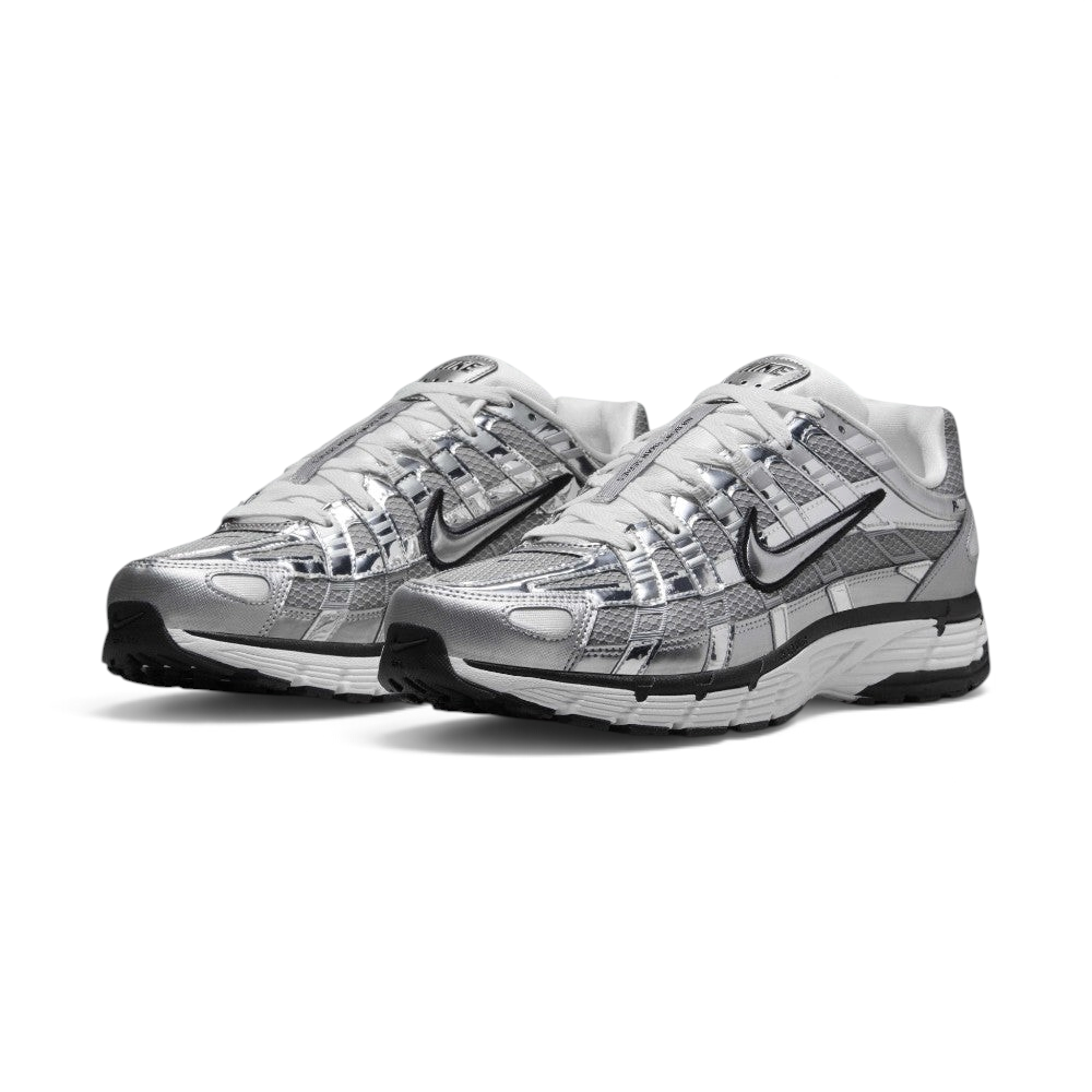 Emphasising the aggressive three-quarter Y2K stance of the trainers and the striking sheen of the metallic silver uppers sitting cleanly above the dual-tone midsoles.