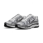 Emphasising the aggressive three-quarter Y2K stance of the trainers and the striking sheen of the metallic silver uppers sitting cleanly above the dual-tone midsoles.