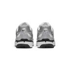 Focuses on the rear profile, highlighting the silver synthetic heel counter with ventilation perforations, micro-Swoosh logos, and the wide white-and-black foam stack below.