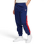 Highlights the high-velocity sweep of the Court Blue panelling tracking down the leg, showing the professional, matte texture of the Sail woven fabric and the clean integration of the zippered side pocket.