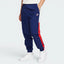Highlights the high-velocity sweep of the Court Blue panelling tracking down the leg, showing the professional, matte texture of the Sail woven fabric and the clean integration of the zippered side pocket.