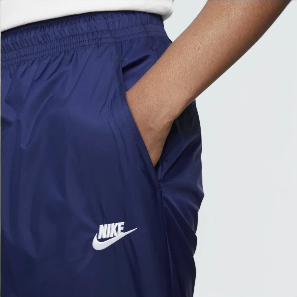 Highlights the crisp, water-shedding texture of the technical Storm-FIT taffeta weave running alongside the premium embroidered corporate Nike Futura logo badge.