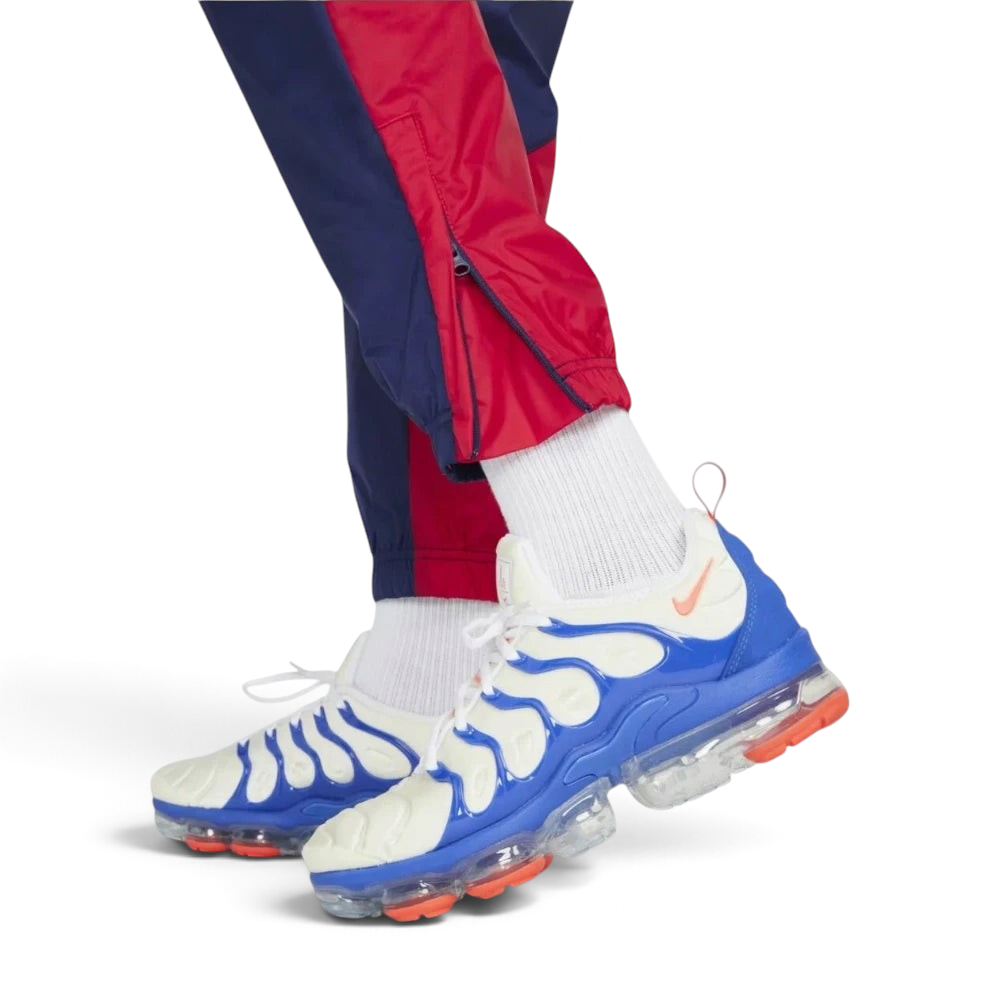 Details the "unreal" precision of the double-reinforced stitching surrounding the lower leg ankle zippers as they rest neatly over your laces.