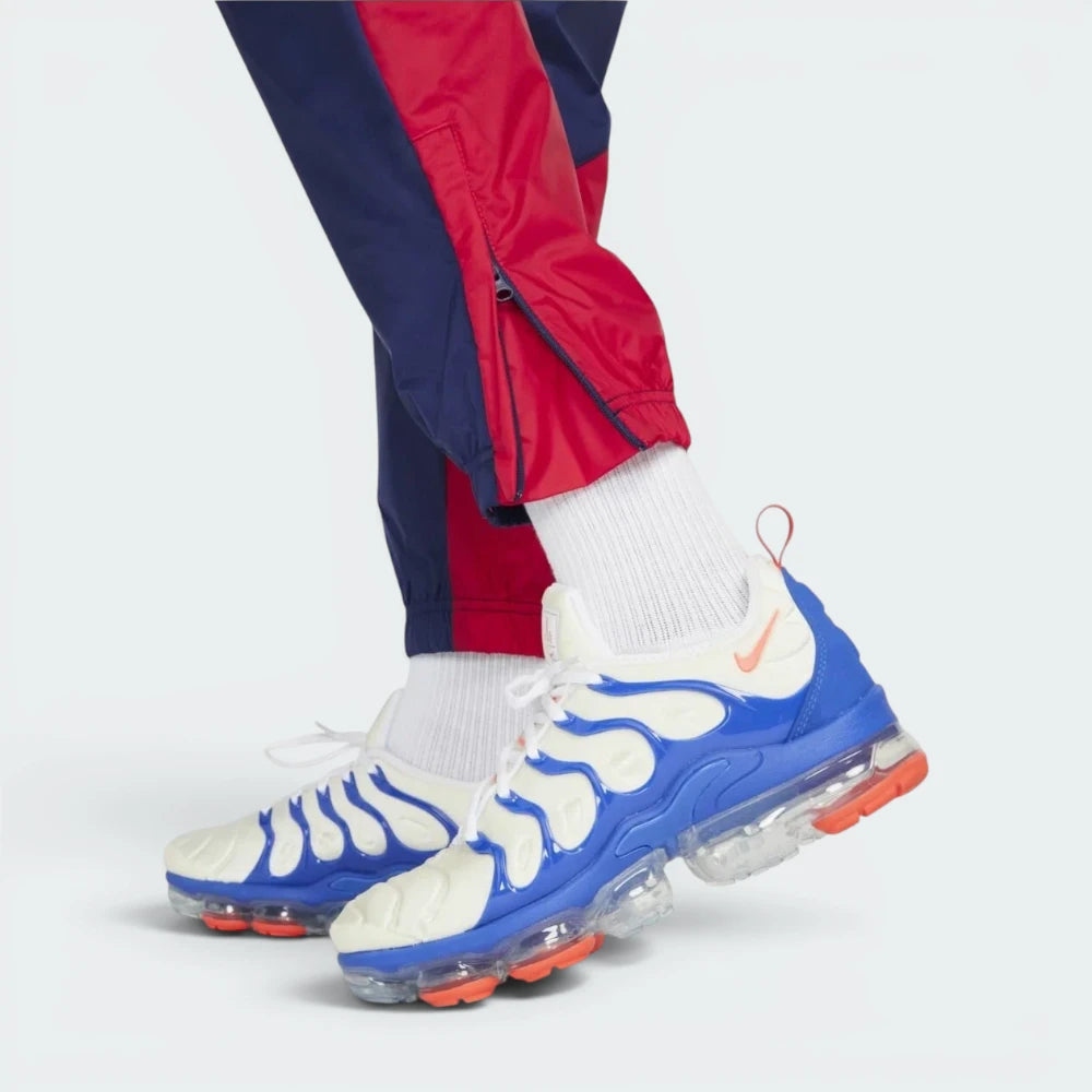 Details the "unreal" precision of the double-reinforced stitching surrounding the lower leg ankle zippers as they rest neatly over your laces.