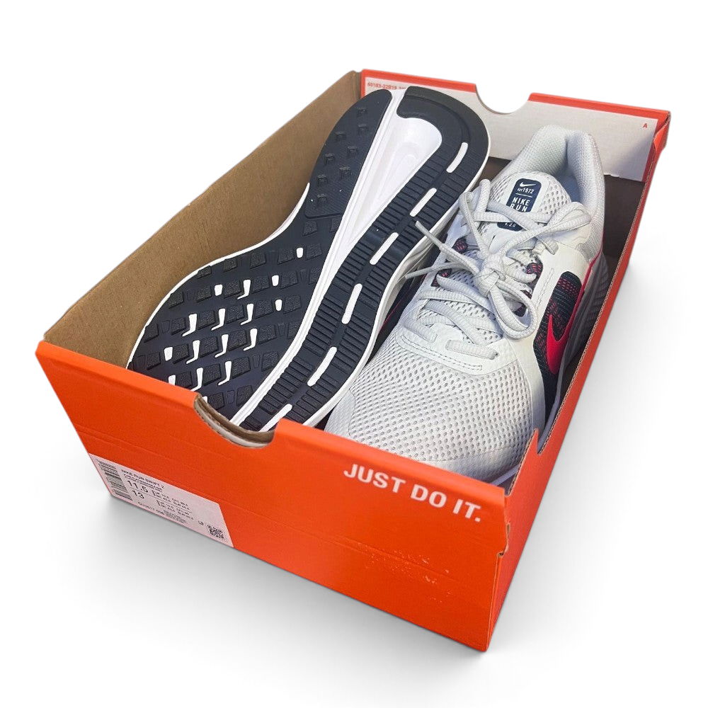 The Nike Run Swift 2 shoes sitting inside an open orange Nike shoebox with no lid, displaying the classic slogan "JUST DO IT." in white on the side of the box.