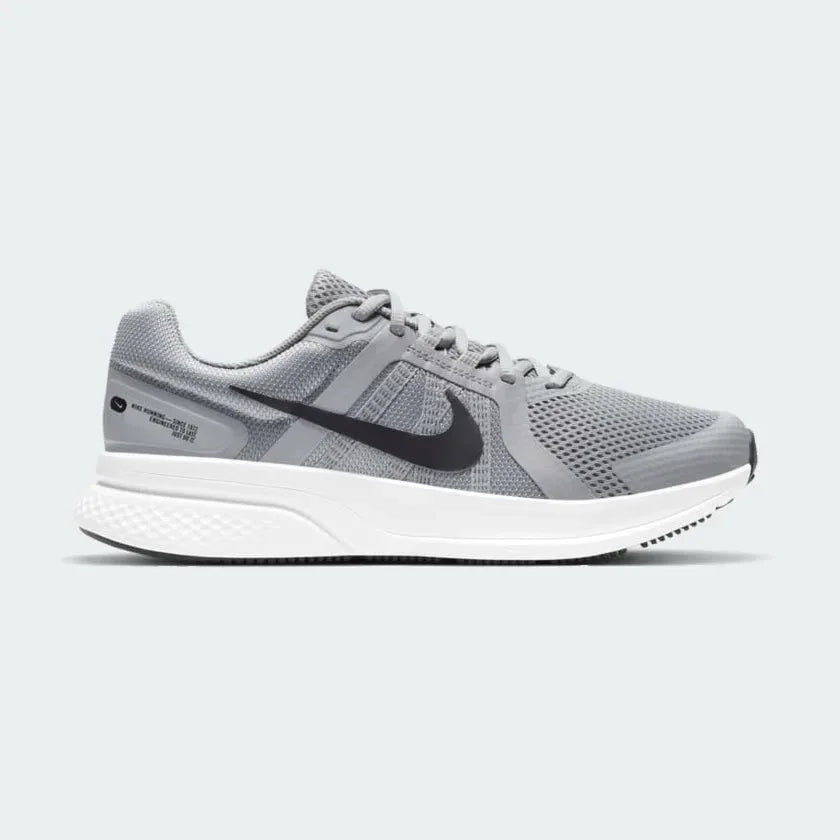 Nike Run Swift 2 Men's running shoes in particle grey with black and white accents, side profile showing breathable mesh upper, foam midsole, and Nike Swoosh.