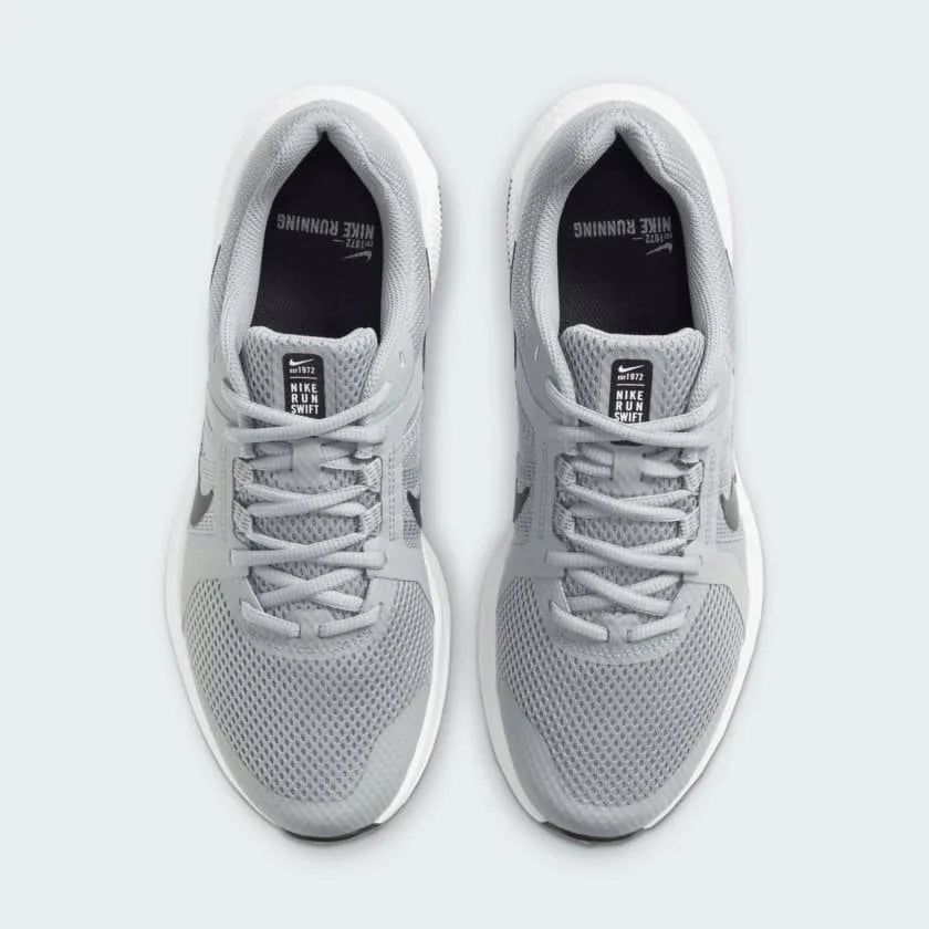Top-down view of a pair of Nike Run Swift 2 Men's running shoes in particle grey, highlighting their streamlined silhouette and lace-up closure.