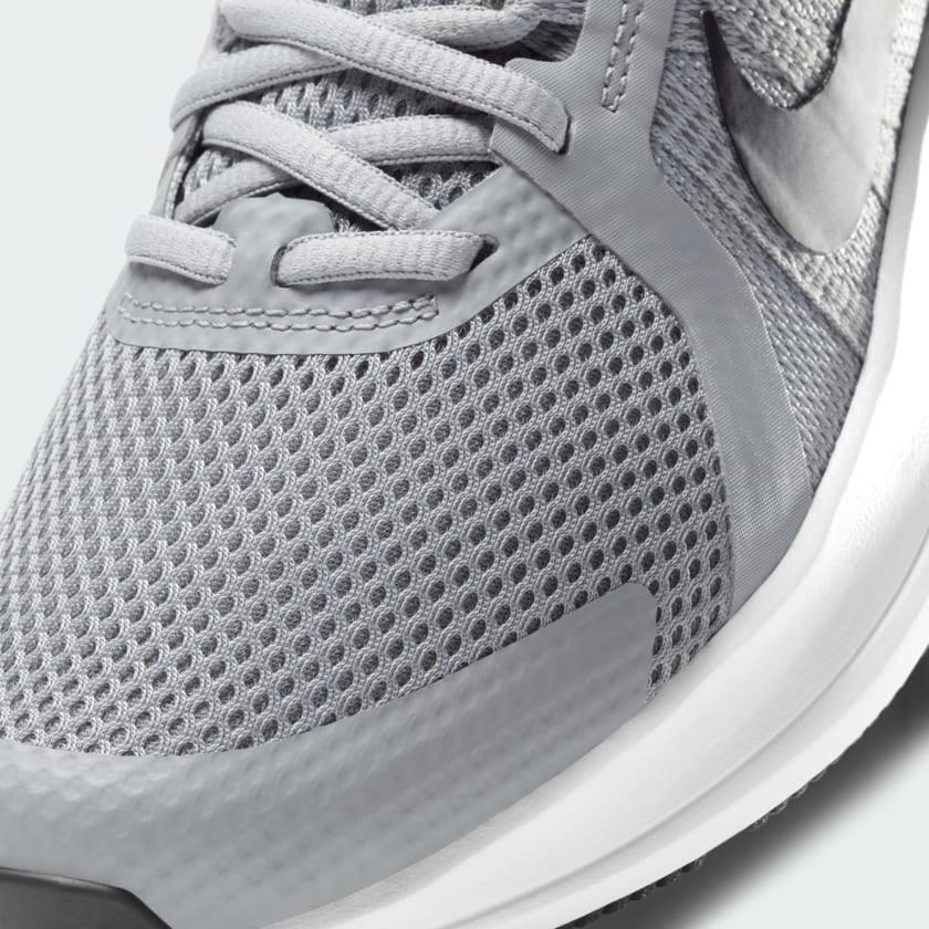 Close-up zoom on the front of the Nike Run Swift 2 Men's particle grey running shoes, showing the mesh upper texture, lacing system, and Flywire cables.