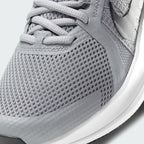 Close-up zoom on the front of the Nike Run Swift 2 Men's particle grey running shoes, showing the mesh upper texture, lacing system, and Flywire cables.
