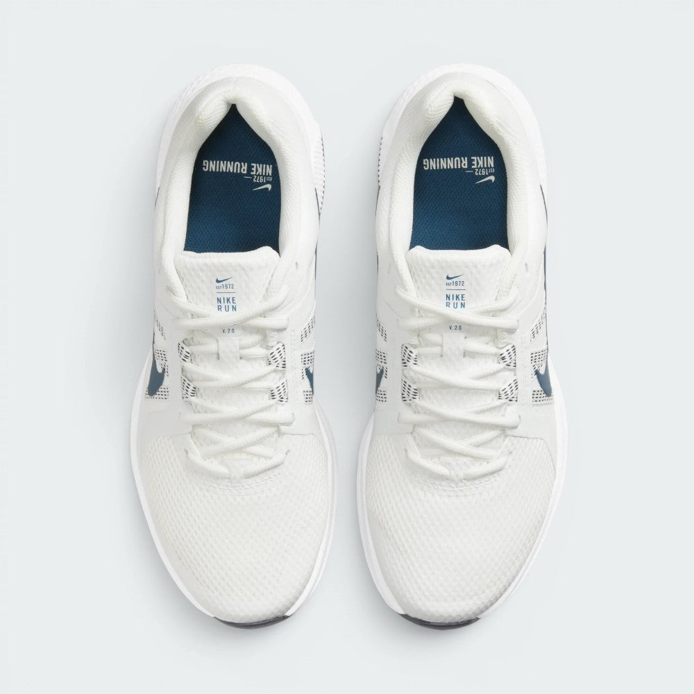 Focuses on the locked-in central lacing layout, displaying the clean symmetry of the white mesh forefoot, midfoot lacing loops, white tongue tags with "NIKE RUN V 2.0" text, and dark blue insoles printed with "NIKE RUNNING" branding.