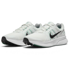 Emphasising the low-cut, athletic stance of the road runners, highlighting the contrast between the crisp white uppers, dark Swooshes, green midfoot strap accents, and green rubber outsole forefoot pods.