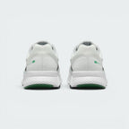 Focuses on the rear profile of both heels, displaying the clean white mesh collars, structured heel cups accented with green oval Swoosh badges, and the wide footprint of the white foam midsoles above the green tread base.