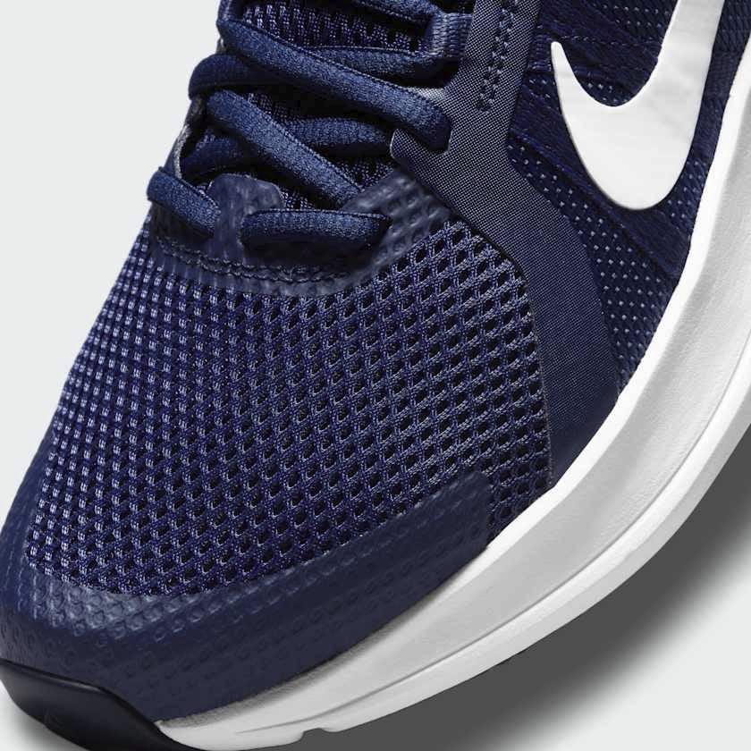 Close-up zoom on the front of the Nike Run Swift 2 Men's navy running shoes, showing the mesh upper texture, lacing system, and Flywire cables.