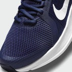 Close-up zoom on the front of the Nike Run Swift 2 Men's navy running shoes, showing the mesh upper texture, lacing system, and Flywire cables.