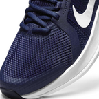 Close-up zoom on the front of the Nike Run Swift 2 Men's navy running shoes, showing the mesh upper texture, lacing system, and Flywire cables.
