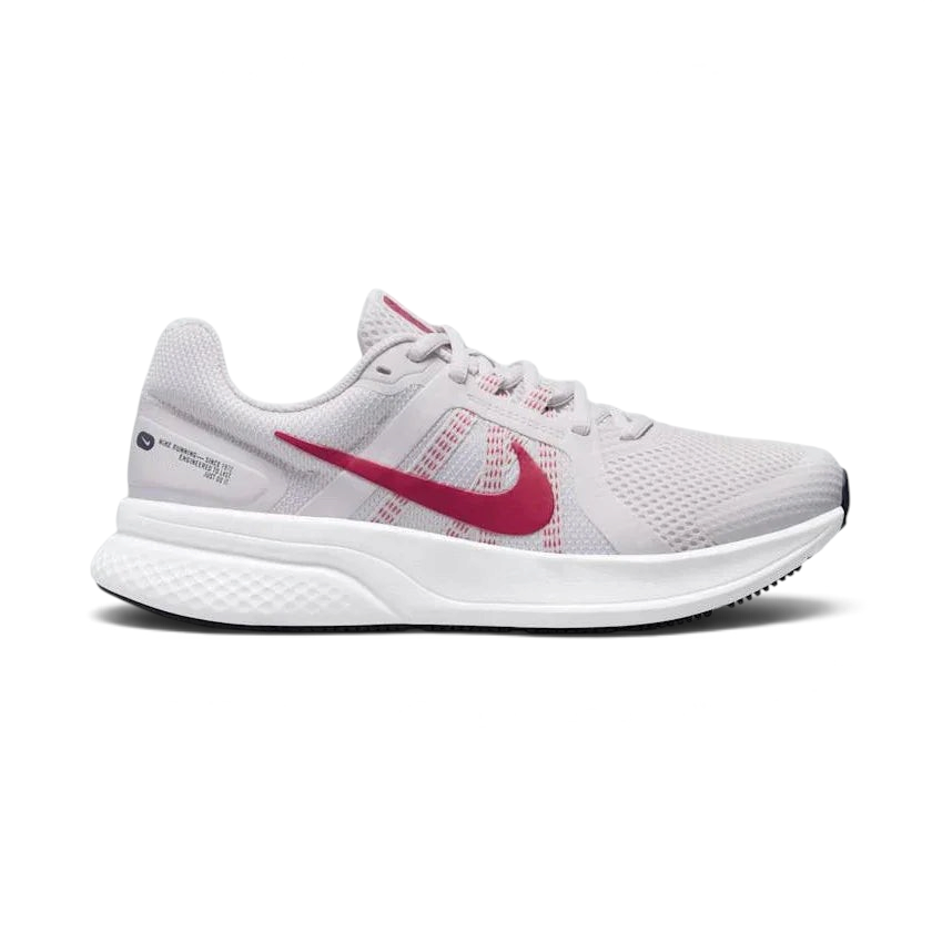 Nike Run Swift 2 Women's running shoes in pink with white accents, side profile showing breathable mesh upper, foam midsole, and Nike Swoosh. Main image