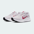 Angled view of two Nike Run Swift 2 Women's pink running shoes, side by side, showcasing their versatile design and cushioned profile.