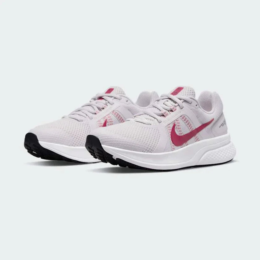 Angled view of two Nike Run Swift 2 Women's pink running shoes, side by side, showcasing their versatile design and cushioned profile.