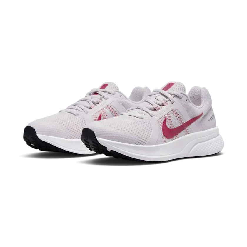 Angled view of two Nike Run Swift 2 Women's pink running shoes, side by side, showcasing their versatile design and cushioned profile.