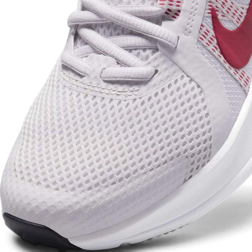 Close-up zoom on the front of the Nike Run Swift 2 Women's pink running shoes, showing the mesh upper texture, lacing system, and Flywire cables.