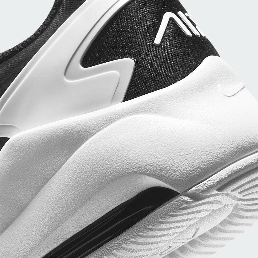 Highlights the "unreal" clean finish where the sculpted white foam midsole meets the durable rubber tread, framing the visible black Max Air cushioning window.