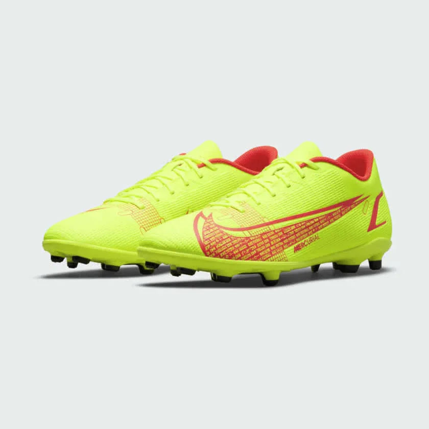 Angled view of two Nike Mercurial Vapor 14 Club FG/MG men's football boots, side by side, displaying their dynamic volt/black/crimson design.