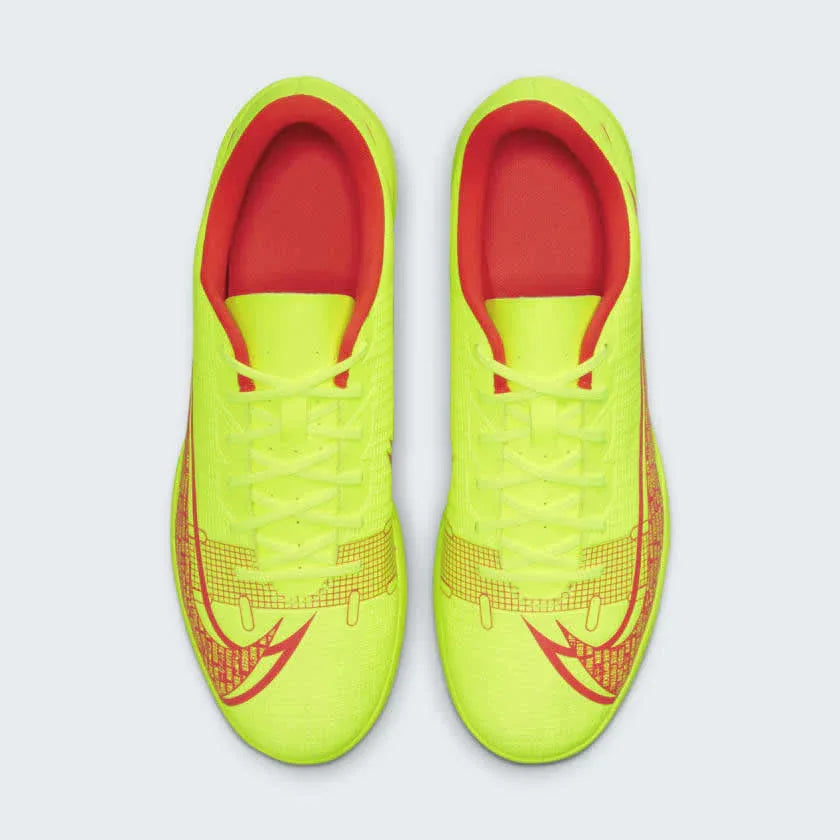Top-down view of a pair of Nike Mercurial Vapor 14 Club IC men's indoor football boots in vibrant volt/black/crimson, showcasing the upper texture.
