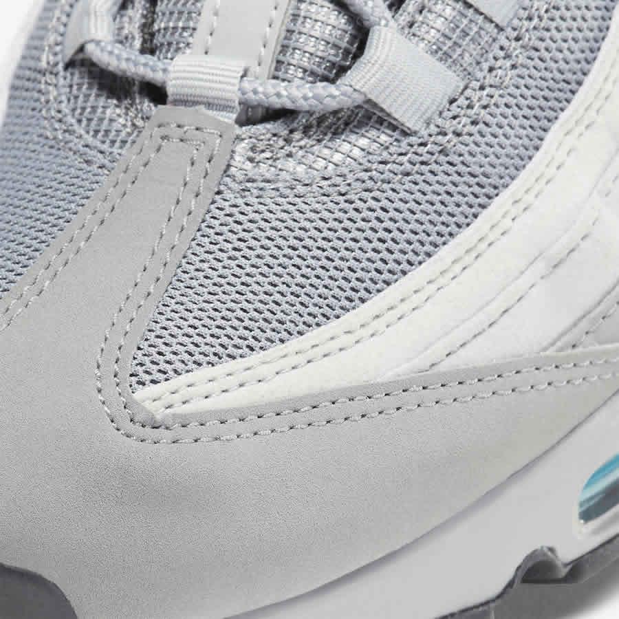 Close-up zoom on the front of the Nike Air Max 95 Men's running shoes, showing the intricate lacing system, mesh tongue, and layered overlays.