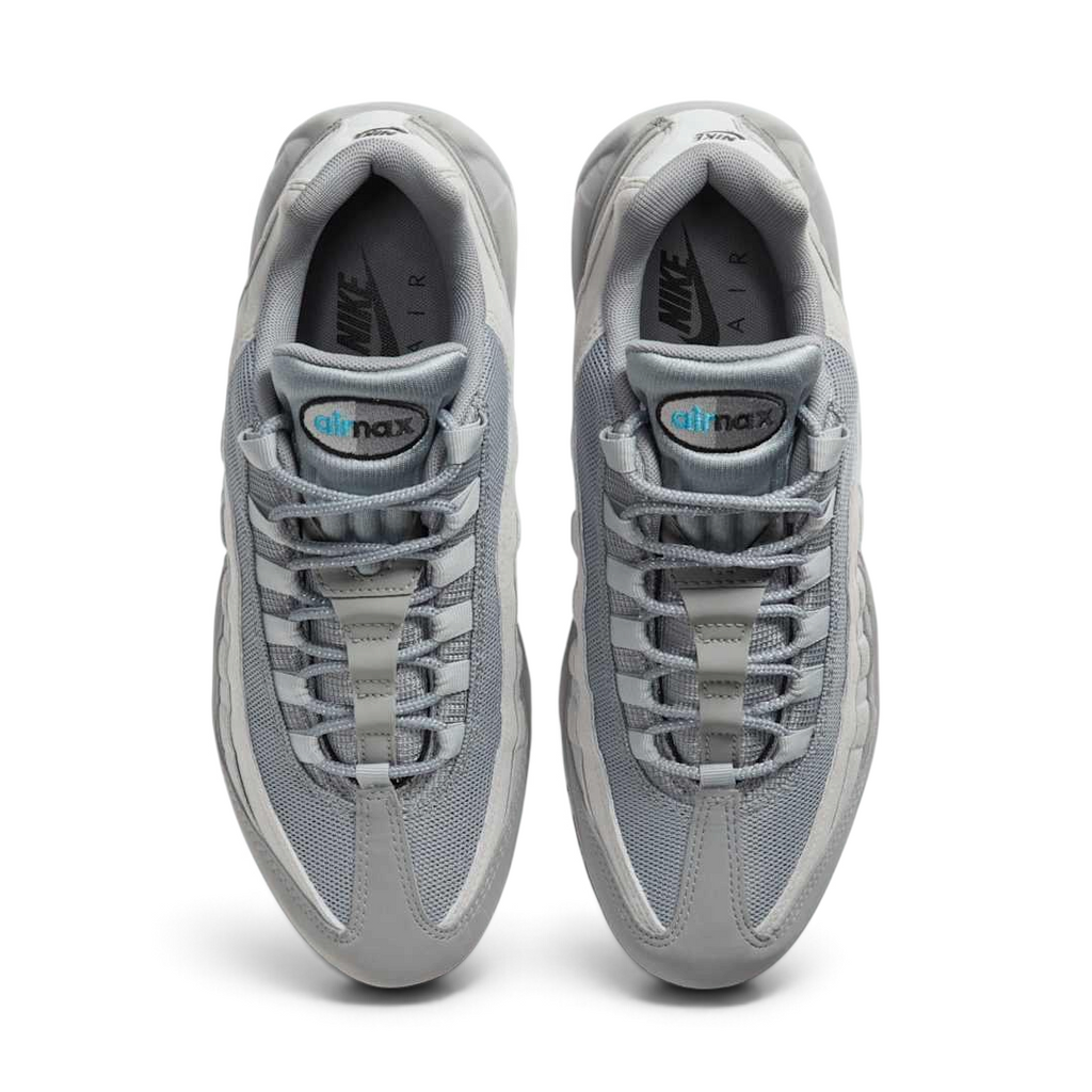 Top-down view of a pair of Nike Air Max 95 Men's running shoes in grey, highlighting their iconic silhouette and lacing system.