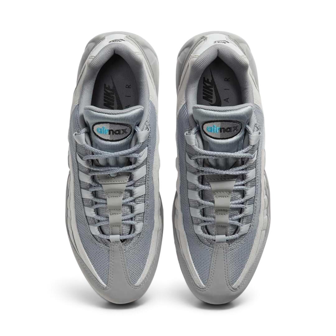 Top-down view of a pair of Nike Air Max 95 Men's running shoes in grey, highlighting their iconic silhouette and lacing system.