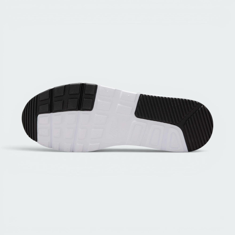 Displays the full-length durable rubber outsole, showcasing the grooved black traction pods on the toe and heel zones interlocked with a central white waffle-inspired grid pattern.