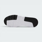 Displays the full-length durable rubber outsole, showcasing the grooved black traction pods on the toe and heel zones interlocked with a central white waffle-inspired grid pattern.