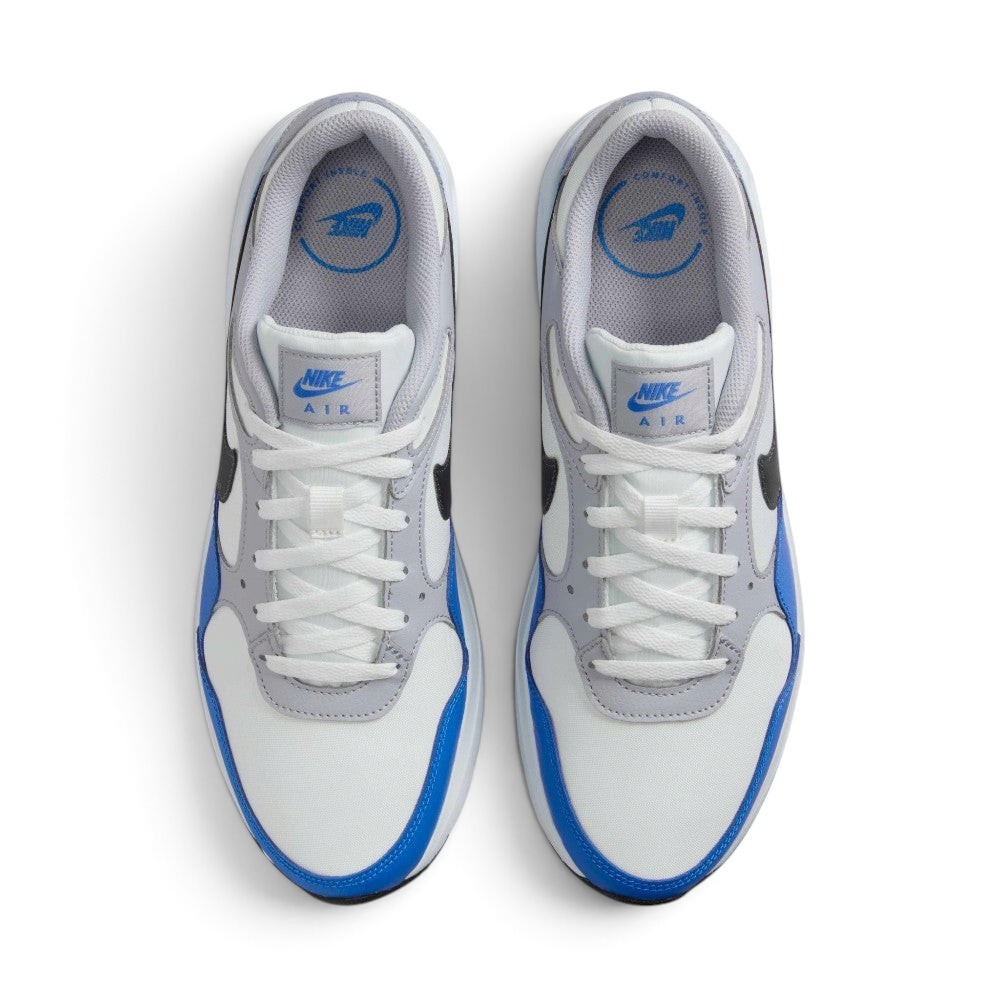Focuses on the locked-in central lacing layout, displaying the clean symmetry of the white mesh tongue, matching white laces, grey eyestay panels, and blue "NIKE AIR" branding printed on the comfort insoles.