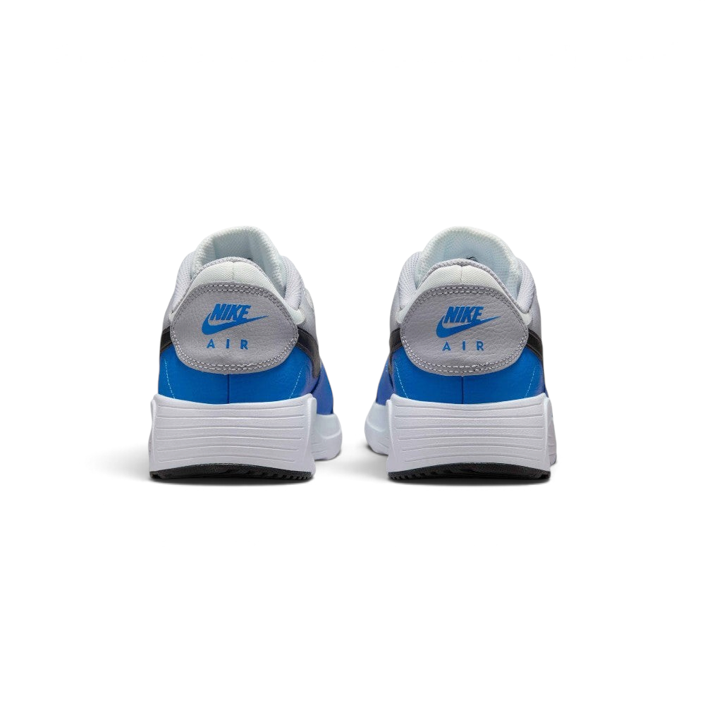 Focuses on the rear profile, highlighting the Wolf Grey leather heel tabs stamped with vibrant blue "NIKE AIR" embroidery, sitting above the wide, clean stack of the white foam midsole base.