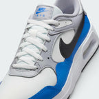 Details the micro-precision of the Summit White mesh toe box, showing the double-stitched Light Photo Blue leather toe mudguard and the neat tracking of the white laces across the grey tongue tag.