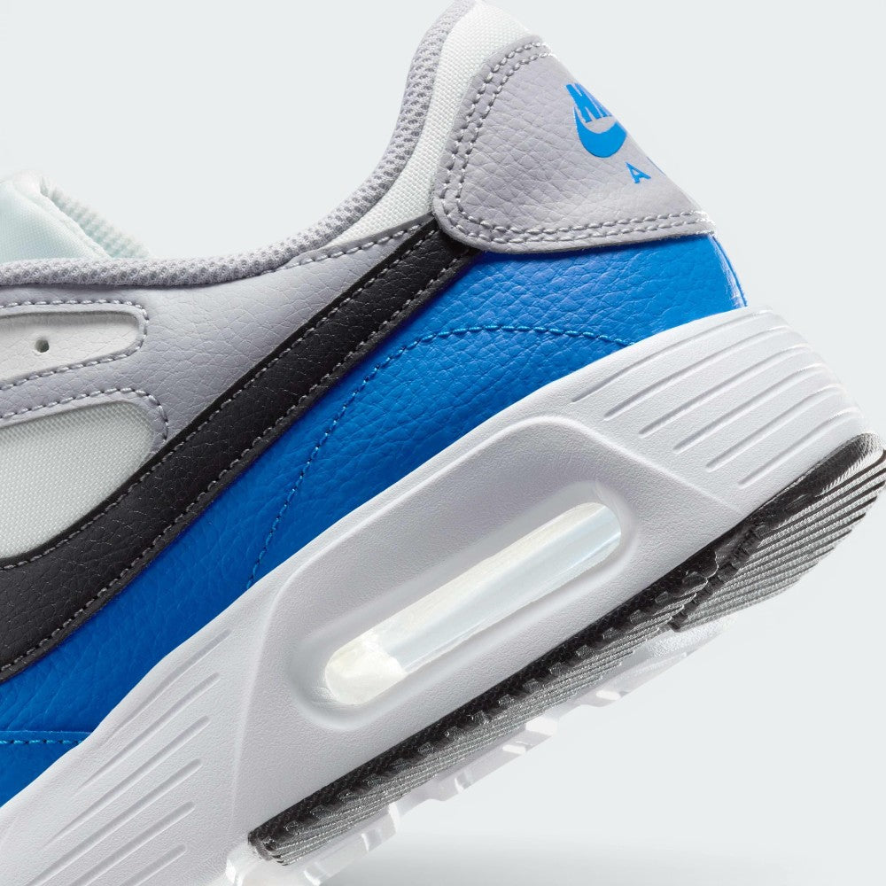 Highlights the "unreal" clean finish where the smooth white foam midsole carrier meets the textured black rubber outsole tread, framing the transparent Max Air cushioning capsule.