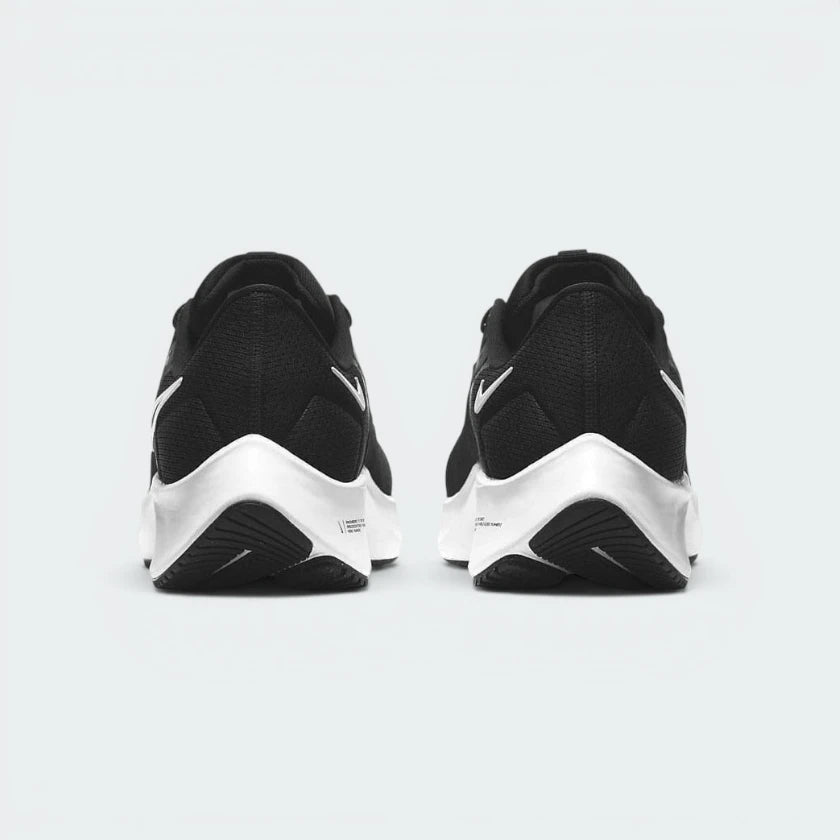 Focuses on the contoured shape of the tapered rear heel collar, highlighting the clean, structural sweep of the rear foam wedge built to relieve Achilles tendon pressure.
