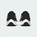 Focuses on the contoured shape of the tapered rear heel collar, highlighting the clean, structural sweep of the rear foam wedge built to relieve Achilles tendon pressure.