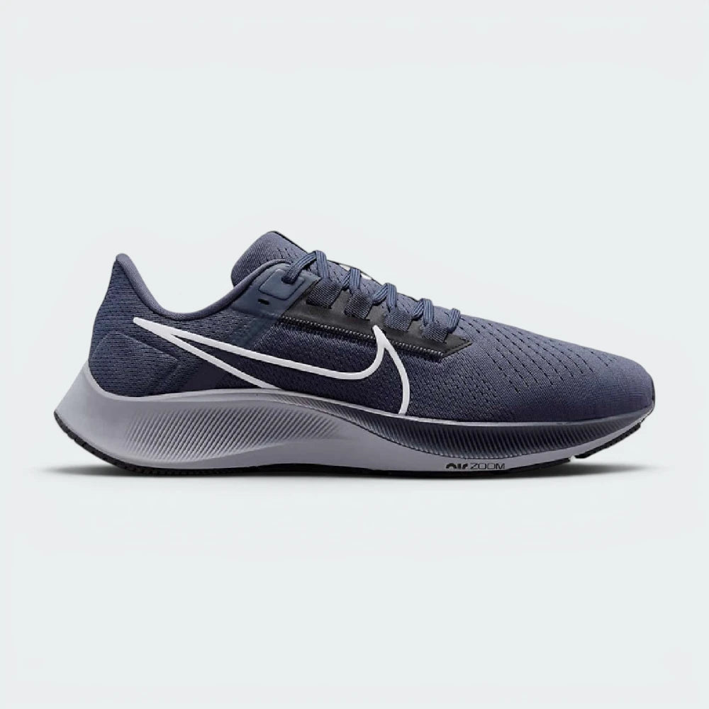 Highlights the high-velocity sweep of the Wolf Grey Nike Swoosh, showing the crisp, dual-tone texture of the Thunder Blue mesh upper resting above the textured black React foam midsole wall. Main image