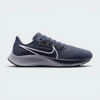 Highlights the high-velocity sweep of the Wolf Grey Nike Swoosh, showing the crisp, dual-tone texture of the Thunder Blue mesh upper resting above the textured black React foam midsole wall.