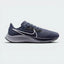 Highlights the high-velocity sweep of the Wolf Grey Nike Swoosh, showing the crisp, dual-tone texture of the Thunder Blue mesh upper resting above the textured black React foam midsole wall.