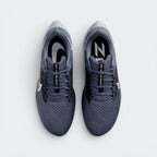 Focuses on the locked-in midfoot webbing layout, displaying the exact symmetry of the extra-padded black tongue and the roomier, wide-cut mesh toe box area.