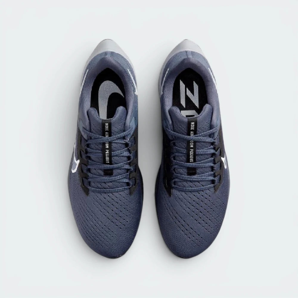 Focuses on the locked-in midfoot webbing layout, displaying the exact symmetry of the extra-padded black tongue and the roomier, wide-cut mesh toe box area.