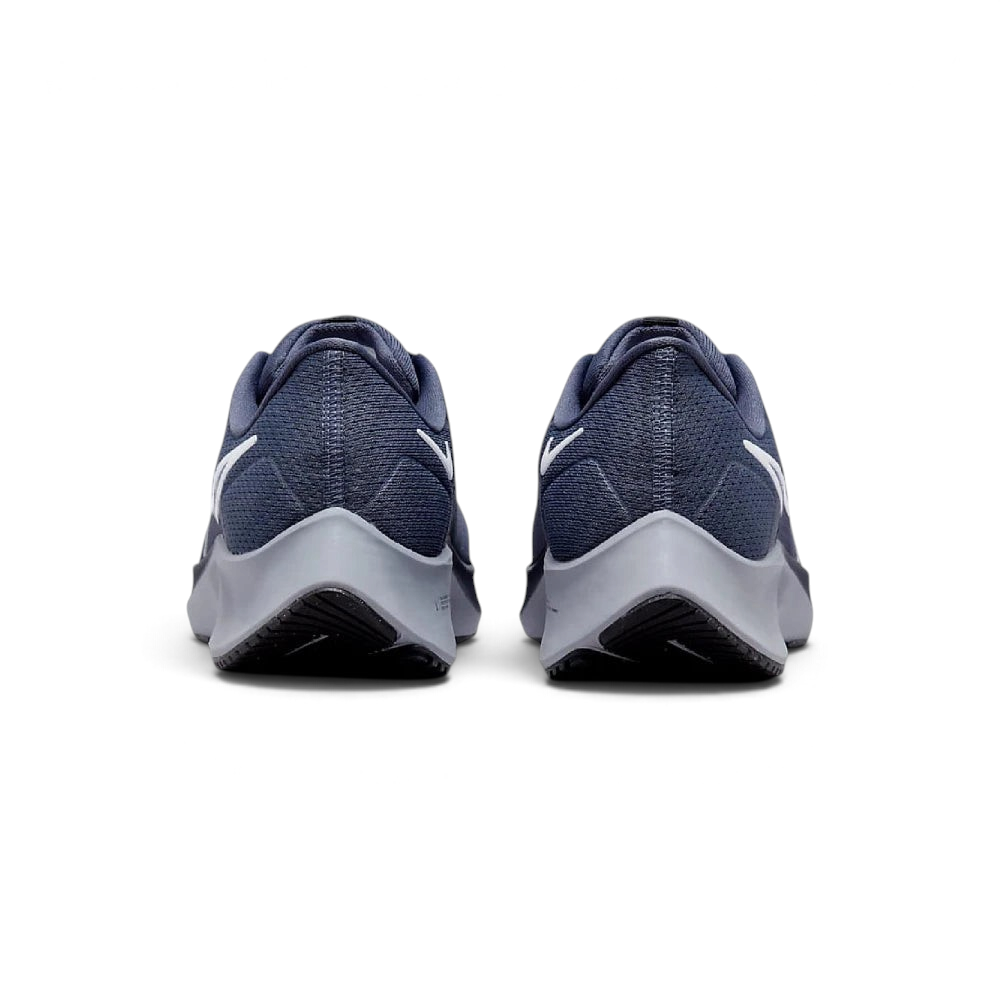 Focuses on the contoured shape of the tapered rear heel collar, highlighting the clean, structural sweep of the rear foam wedge built to relieve Achilles tendon pressure.