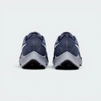 Focuses on the contoured shape of the tapered rear heel collar, highlighting the clean, structural sweep of the rear foam wedge built to relieve Achilles tendon pressure.