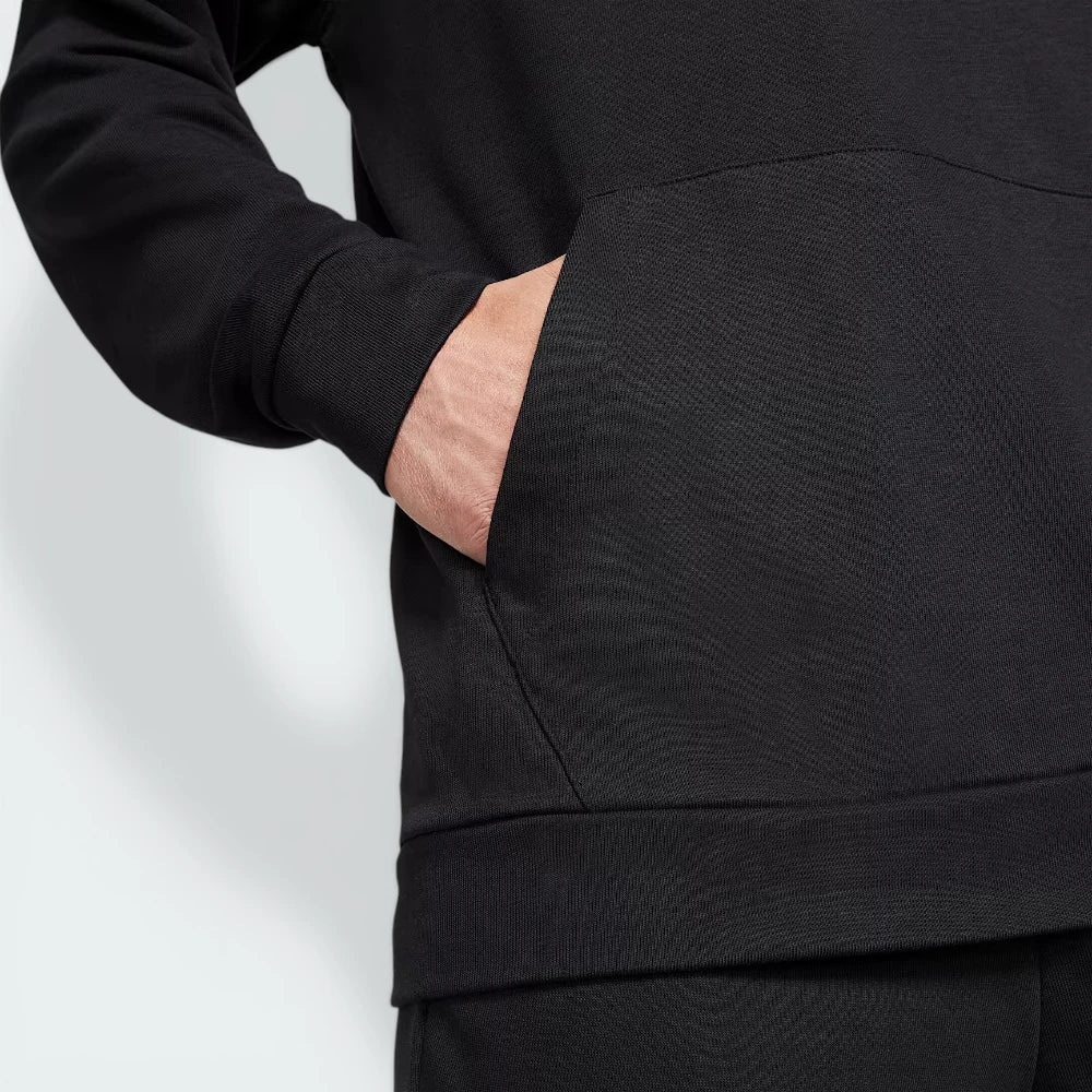 Detailed zoom on the ribbed hem and sustainable material tag, highlighting the premium eco-friendly manufacturing.