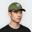 Highlights the high-velocity visual contrast of the solid Wild Pine crown paneling sitting perfectly above the professional, earth-toned grid depth of the camouflage printed brim.