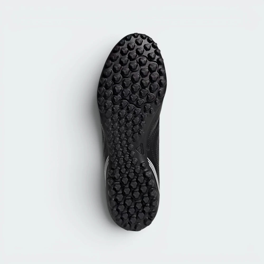 Displays the technical lugged pattern designed for unreal artificial turf traction.